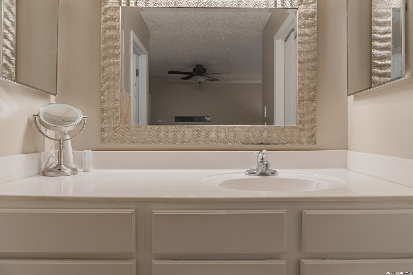 8942 Willmon Way Windcrest, TX 78239 - Photo 31 of 44 a bathroom with a sink and a mirror