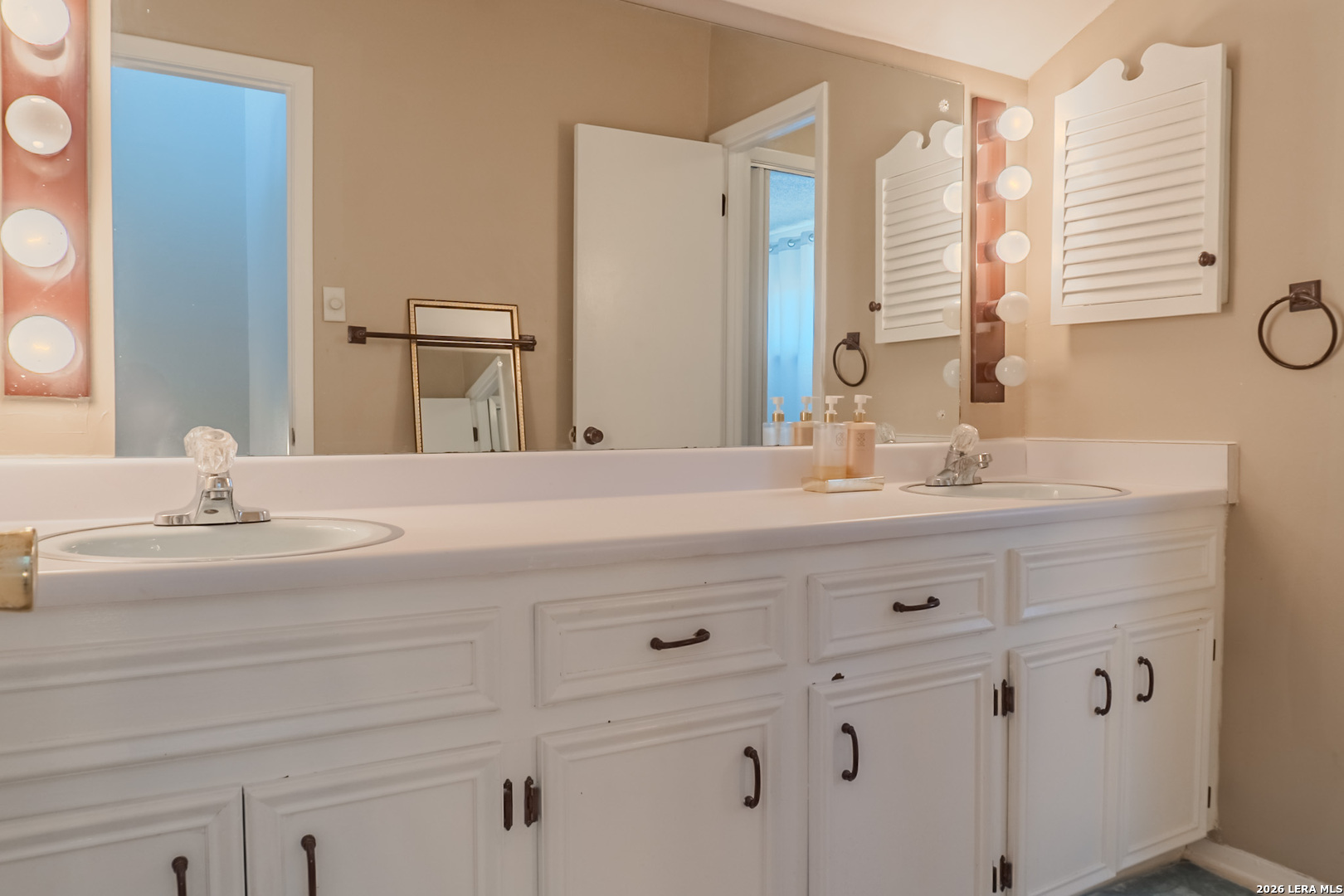 8942 Willmon Way Windcrest, TX 78239 - Photo 38 of 44 a bathroom with a sink vanity and a mirror