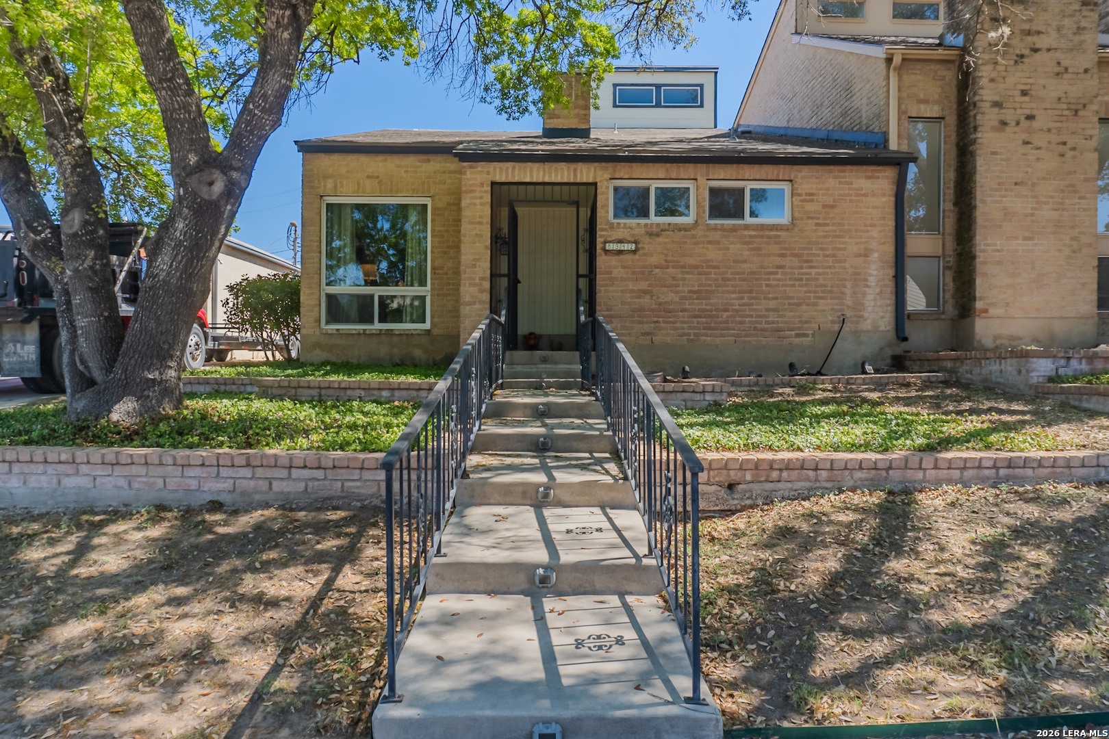 8942 Willmon Way Windcrest, TX 78239 - Photo 4 of 44 a front view of a house with a yard