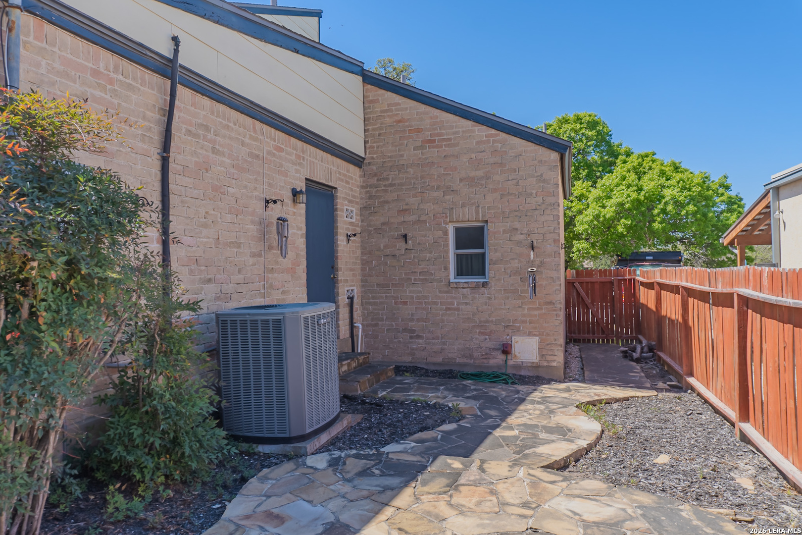 8942 Willmon Way Windcrest, TX 78239 - Photo 41 of 44 a view of a backyard with wooden fence and potted plants