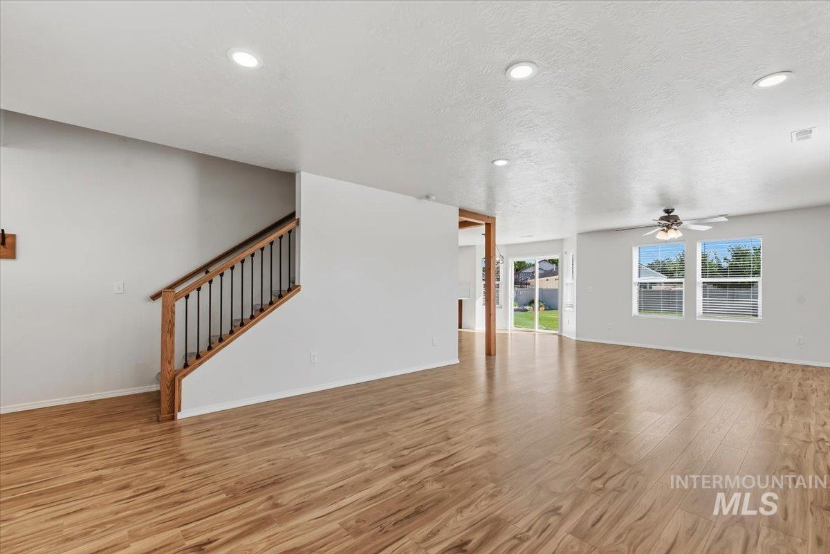 12310 West Hidden Point Drive Star, ID 83669 - Photo 31 of 48 Spacious living area featuring wood-finish flooring, recessed lighting, and a ceiling fan