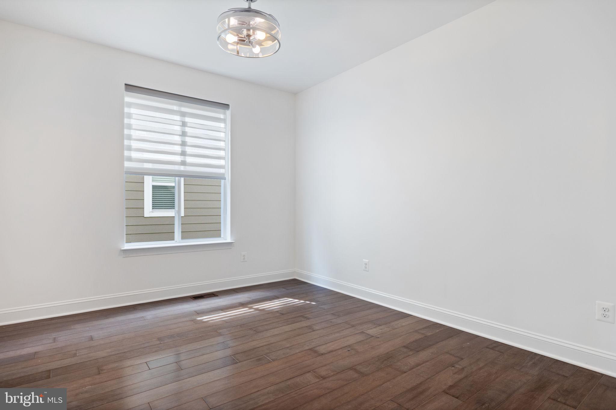 112 Flycatcher Way White Post, VA 22663 - Photo 12 of 59 a view of an empty room with wooden floor and a window