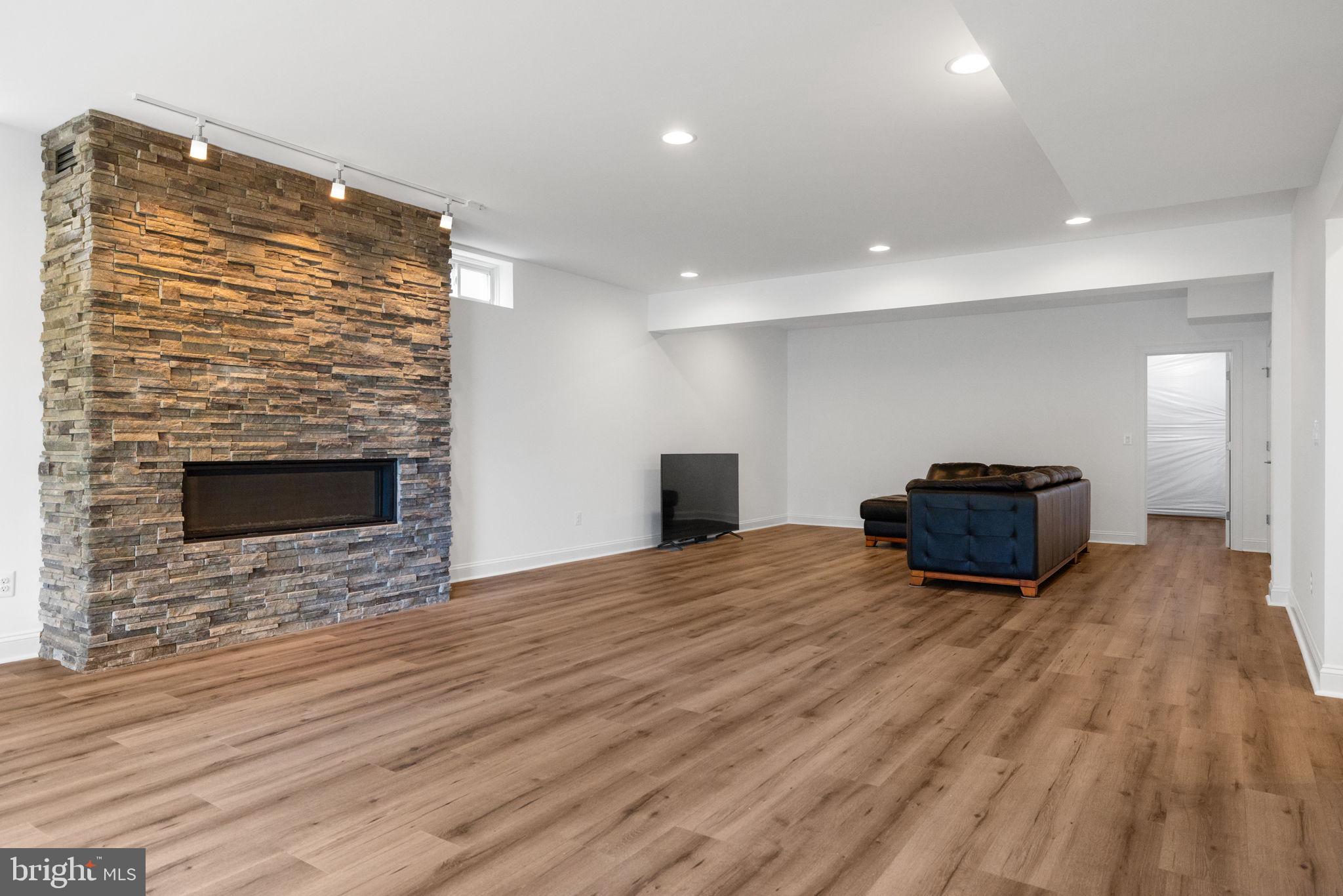 112 Flycatcher Way White Post, VA 22663 - Photo 35 of 59 a view of a livingroom with wooden floor and a fireplace