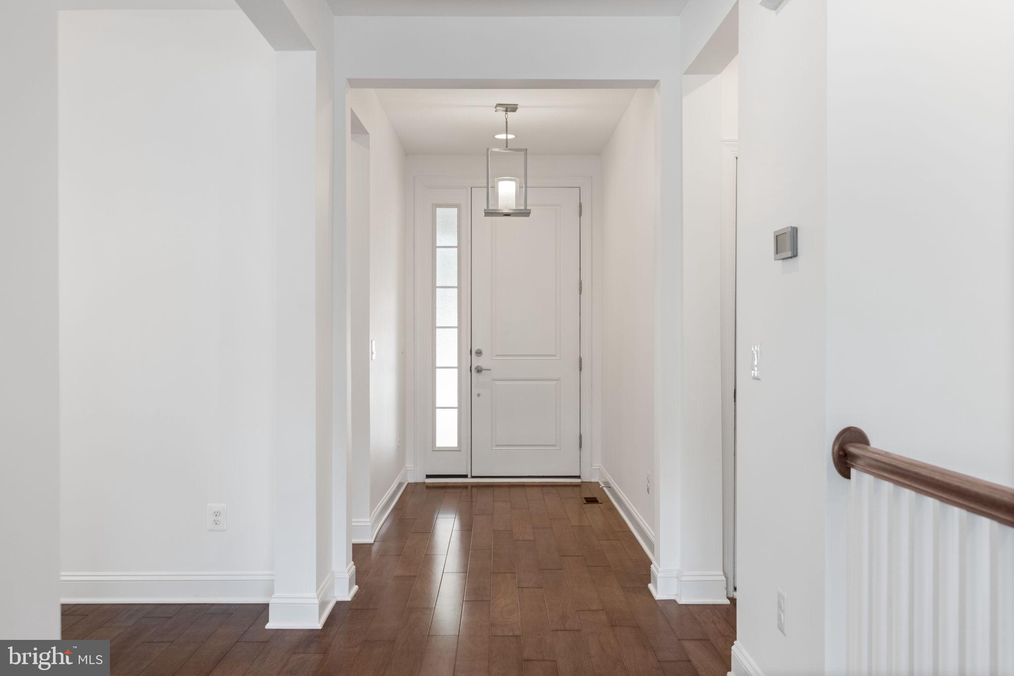 112 Flycatcher Way White Post, VA 22663 - Photo 4 of 59 a view of a hallway with wooden floor and glass door