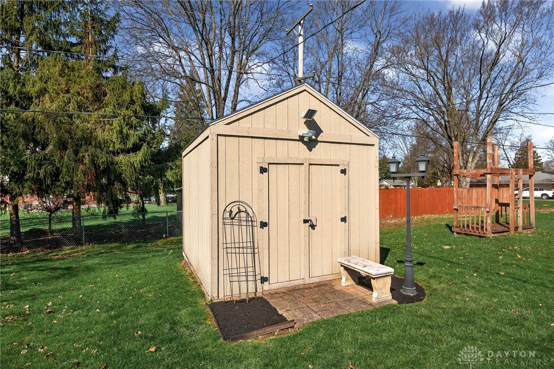 5907 Red Coach Road Dayton, OH 45429 - Photo 48 of 50 This charming backyard shed offers additional storage and outdoor utility, complementing the spacious green yard.