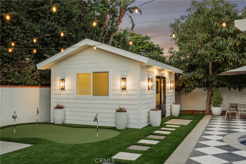 13822 Henstridge Circle Tustin, CA 92780 - Photo 17 of 61 a view of a white house next to a yard with big trees