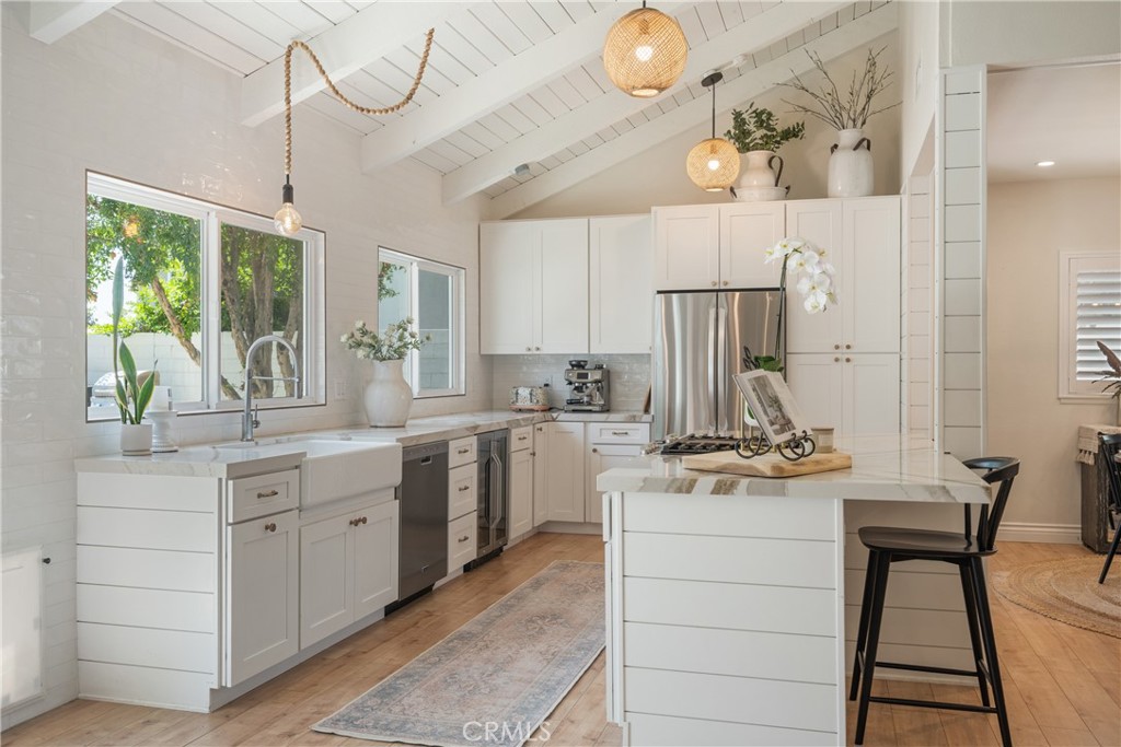 13822 Henstridge Circle Tustin, CA 92780 - Photo 19 of 61 a kitchen with a stove a sink and a refrigerator