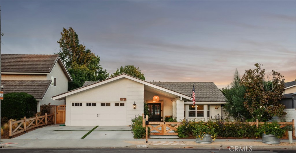 13822 Henstridge Circle Tustin, CA 92780 - Photo 2 of 61 a view of a white house with a small yard and a large window