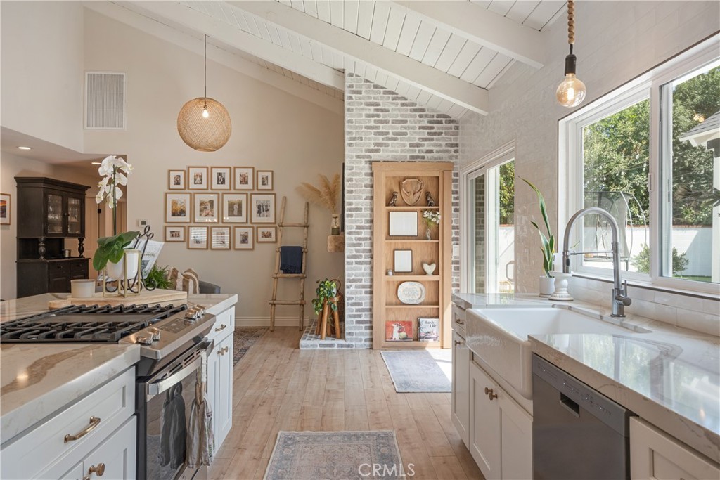 13822 Henstridge Circle Tustin, CA 92780 - Photo 23 of 61 a kitchen with a stove and a sink