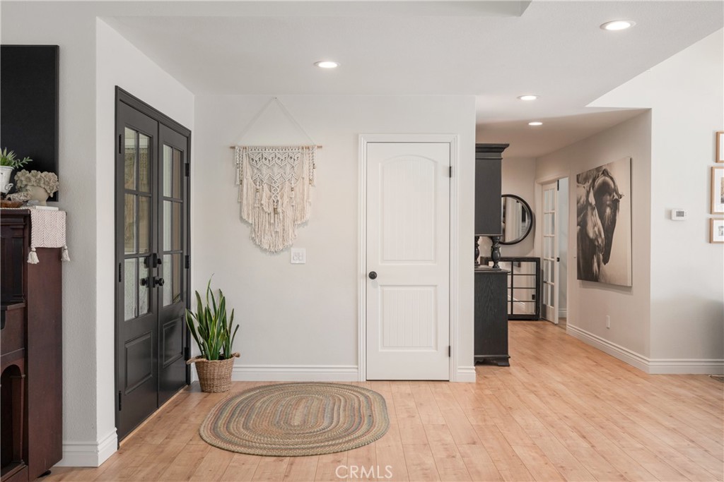 13822 Henstridge Circle Tustin, CA 92780 - Photo 33 of 61 a view of a hallway with wooden floor and a potted plant