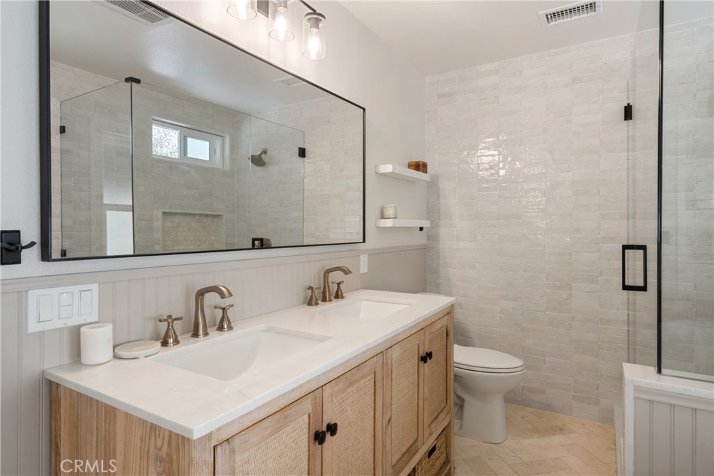 13822 Henstridge Circle Tustin, CA 92780 - Photo 42 of 61 a bathroom with a sink toilet and mirror