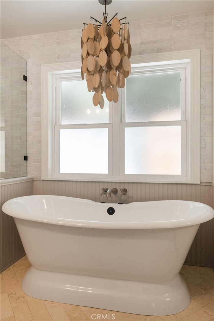 13822 Henstridge Circle Tustin, CA 92780 - Photo 43 of 61 a bathroom with a bathtub and a window