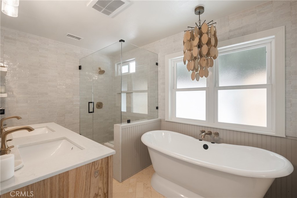 13822 Henstridge Circle Tustin, CA 92780 - Photo 44 of 61 a bathroom with a tub sink and mirror