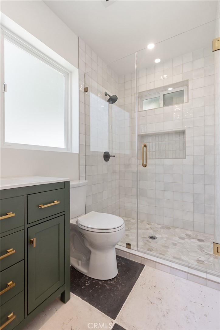 13822 Henstridge Circle Tustin, CA 92780 - Photo 55 of 61 a bathroom with a toilet sink and shower