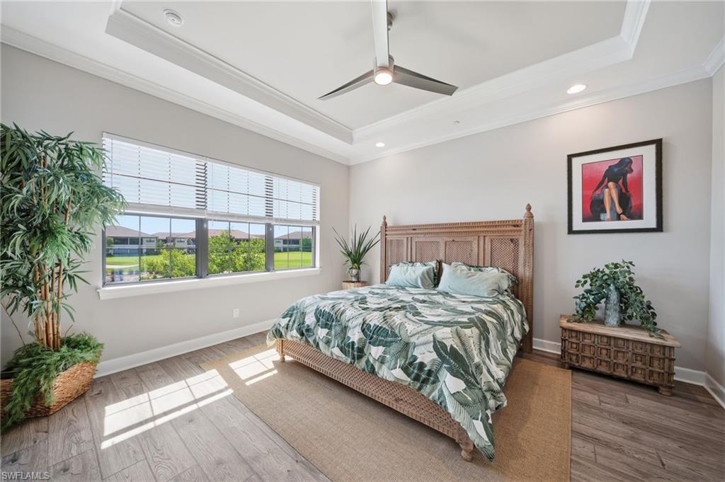 9658 Montelanico Loop, Unit 201 Naples, FL 34119 - Photo 7 of 46 a bed sitting in a spacious bedroom next to a window