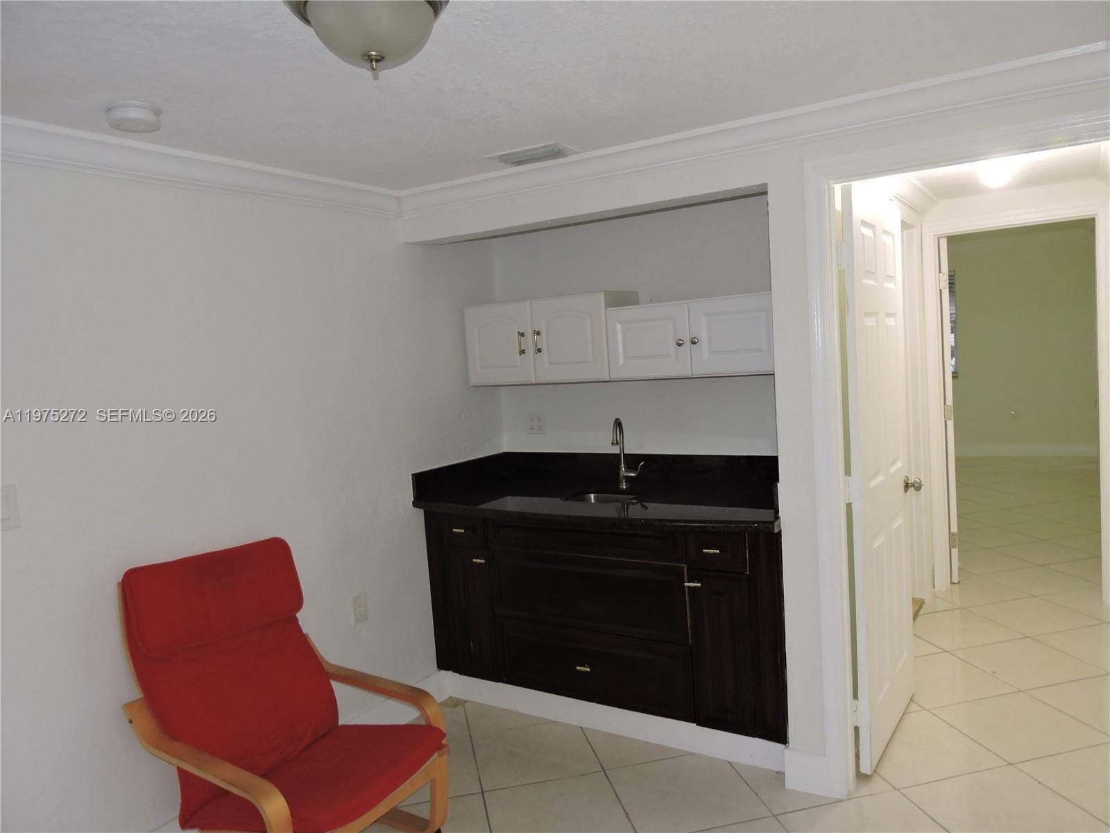 551 East 39th Street Hialeah, FL 33013 - Photo 11 of 14 a room with a chair and a chair