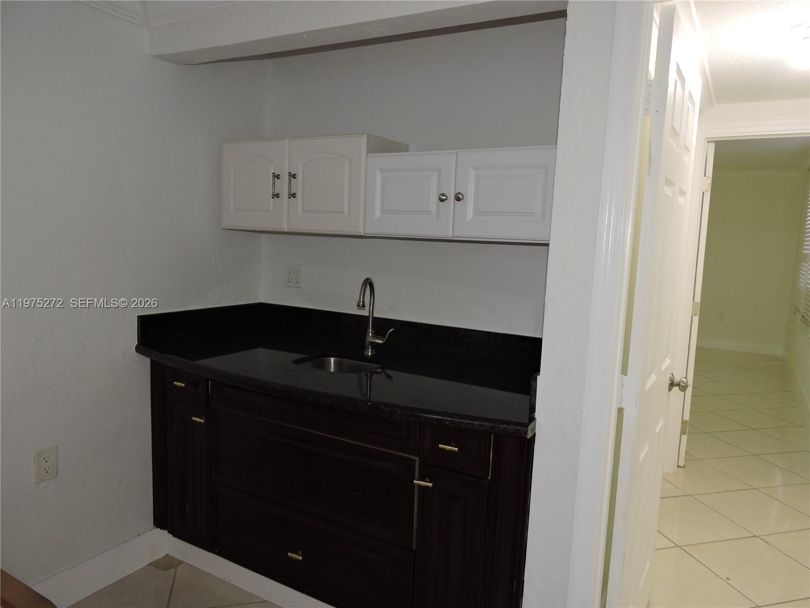 551 East 39th Street Hialeah, FL 33013 - Photo 13 of 14 a kitchen with a sink and cabinets