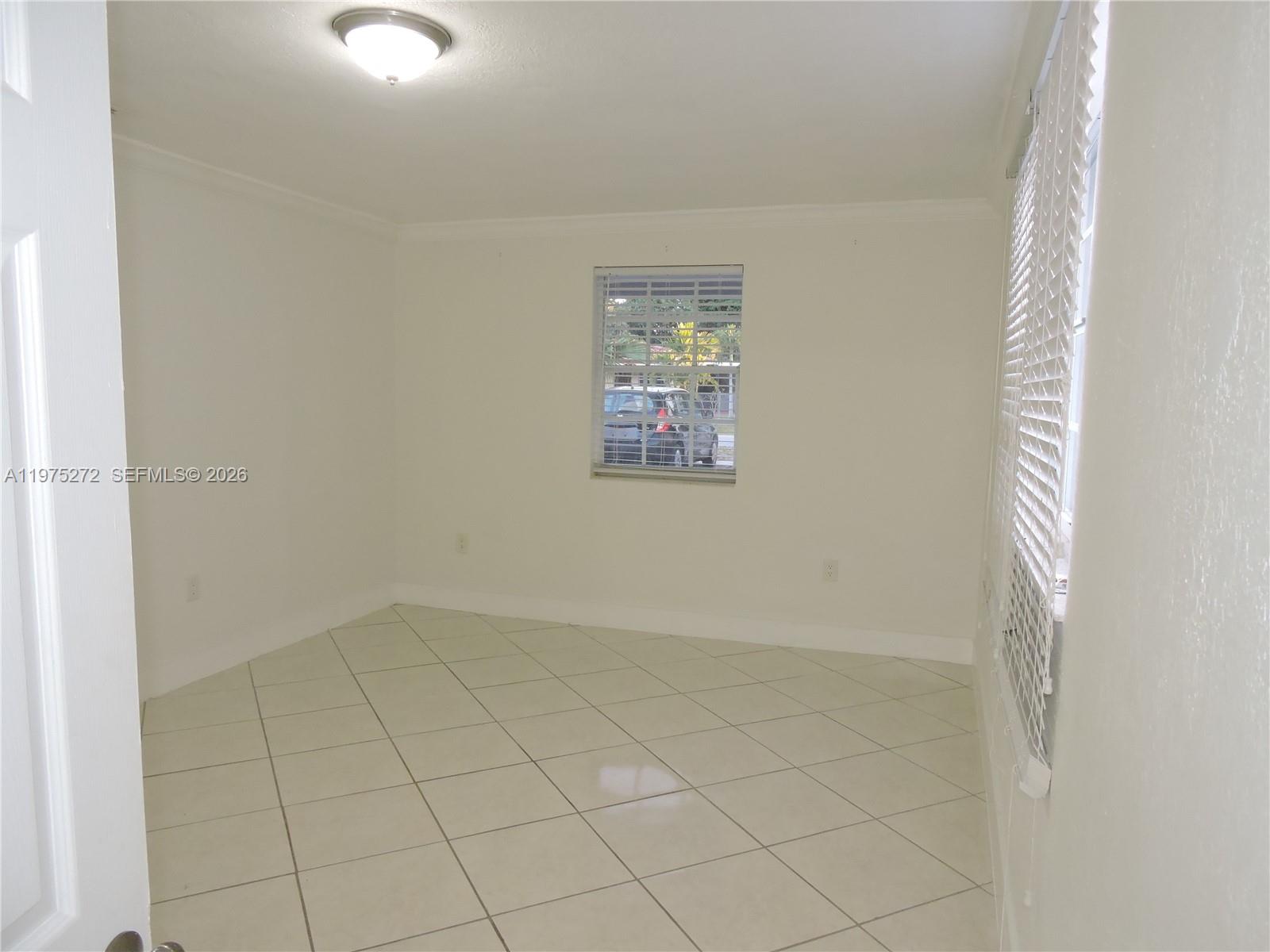 551 East 39th Street Hialeah, FL 33013 - Photo 2 of 14 an empty room with windows