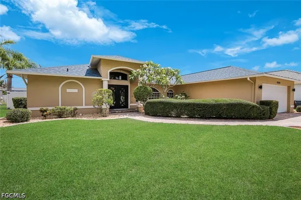 a front view of a house with a garden