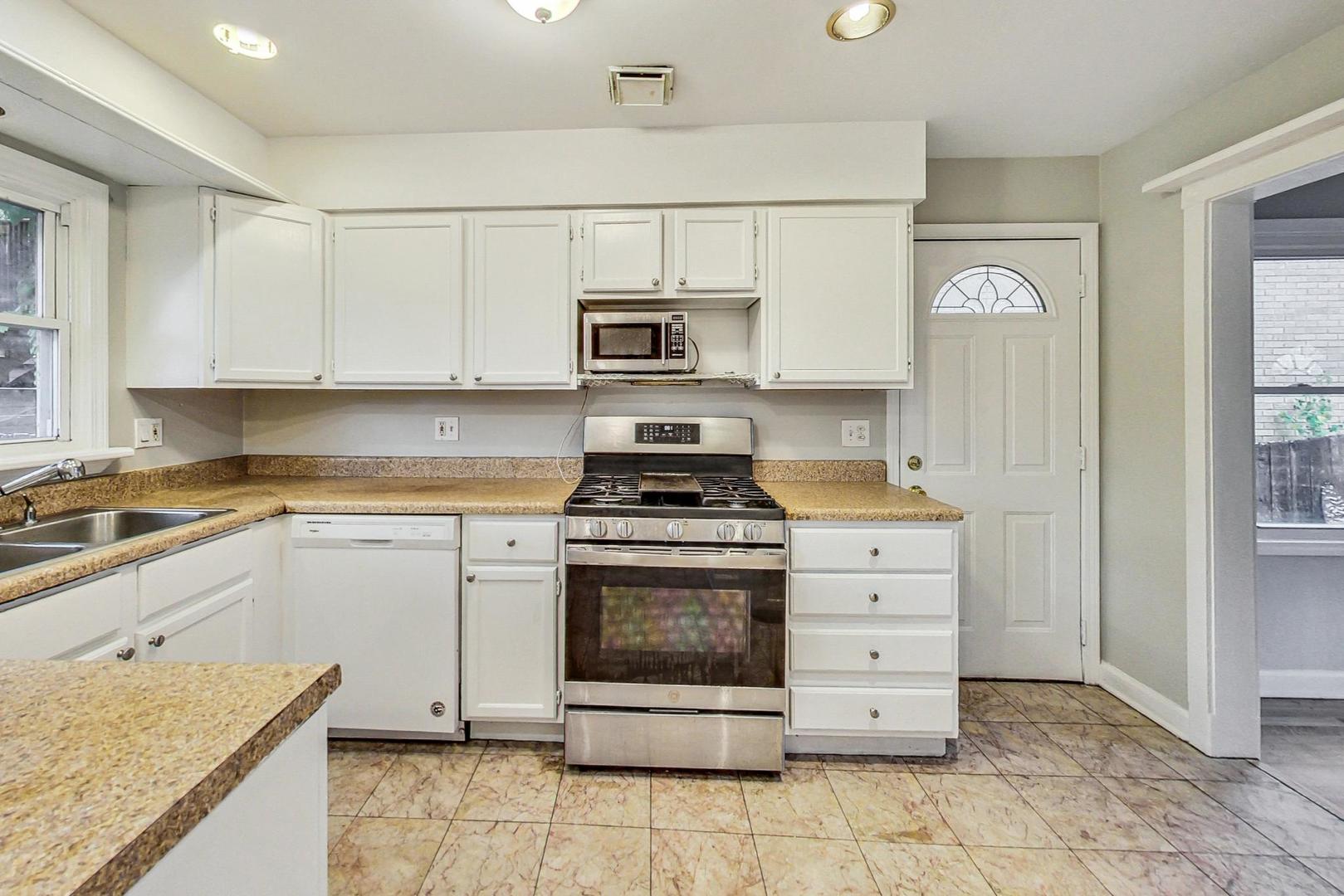 2212-2214 Oakton Street Park Ridge, IL 60068 - Photo 11 of 43 a kitchen with cabinets stainless steel appliances and a counter space