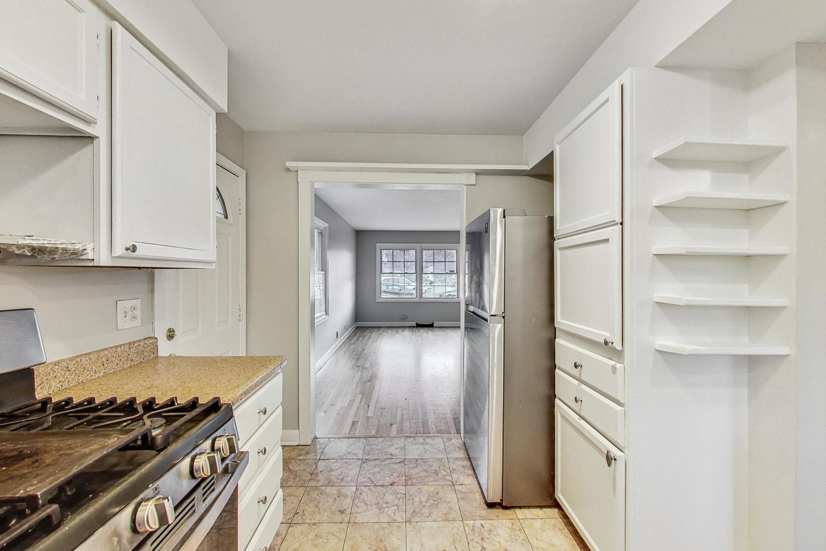 2212-2214 Oakton Street Park Ridge, IL 60068 - Photo 12 of 43 a kitchen with granite countertop a stove and a refrigerator
