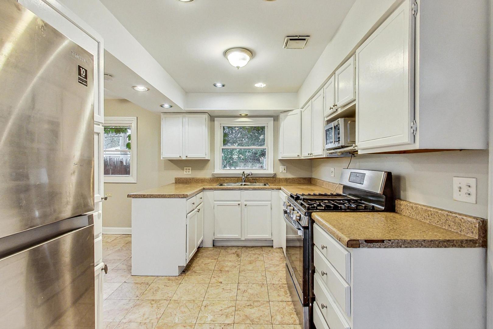 2212-2214 Oakton Street Park Ridge, IL 60068 - Photo 13 of 43 a kitchen with stainless steel appliances granite countertop a stove a sink and a refrigerator