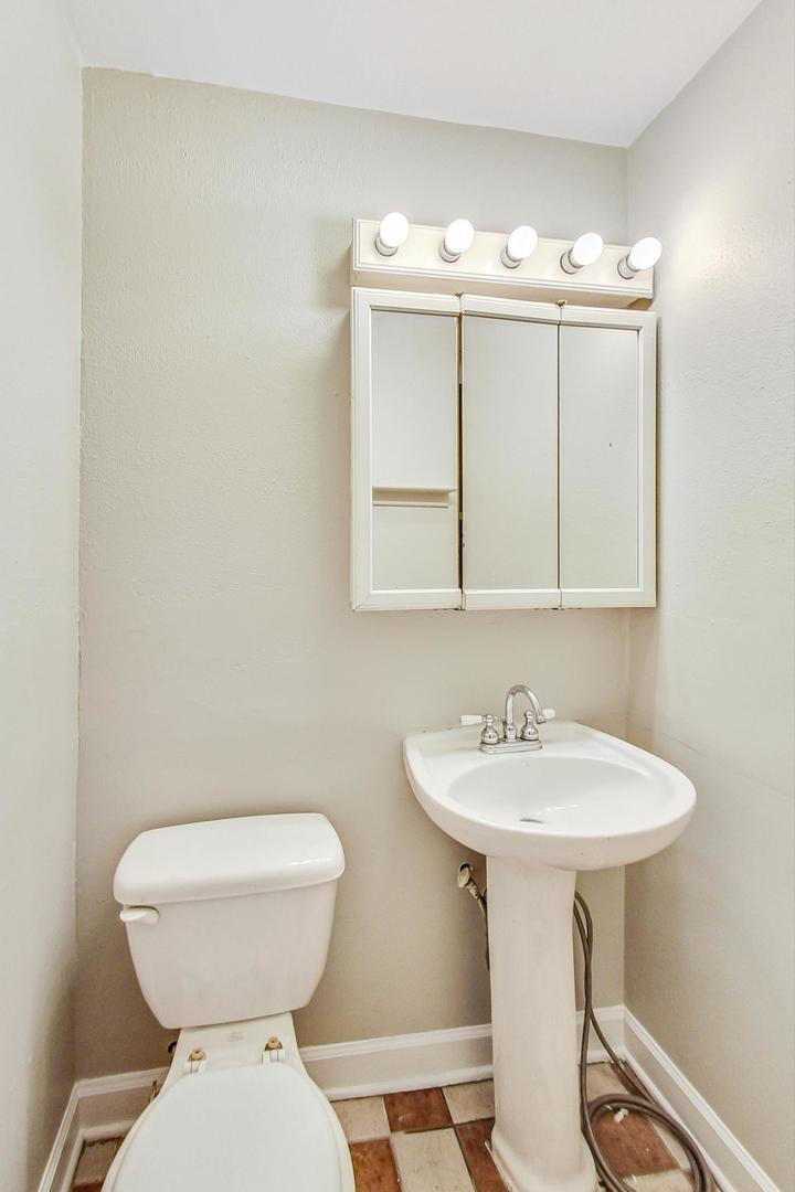 2212-2214 Oakton Street Park Ridge, IL 60068 - Photo 14 of 43 a bathroom with a sink and a toilet