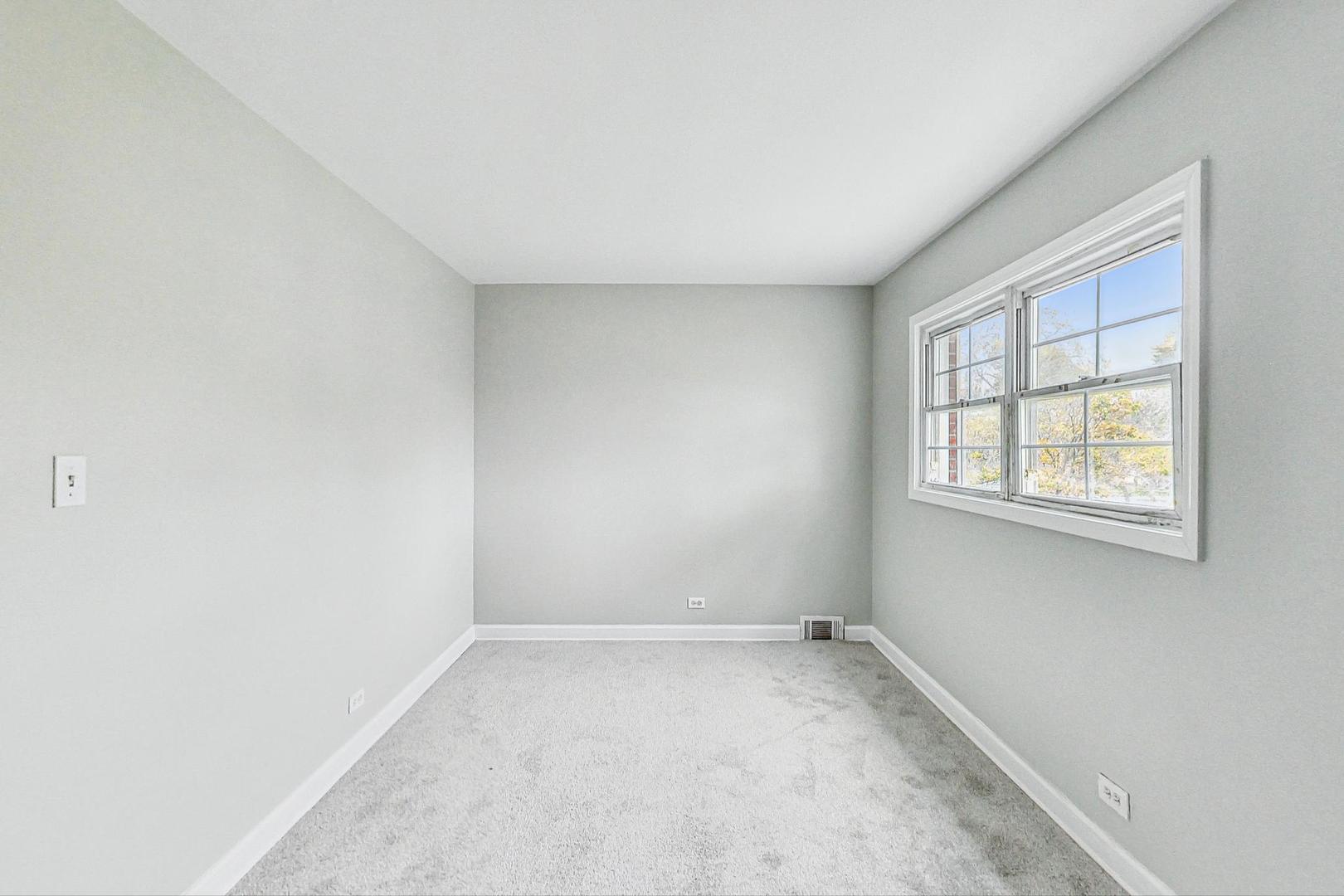 2212-2214 Oakton Street Park Ridge, IL 60068 - Photo 16 of 43 an empty room with a window
