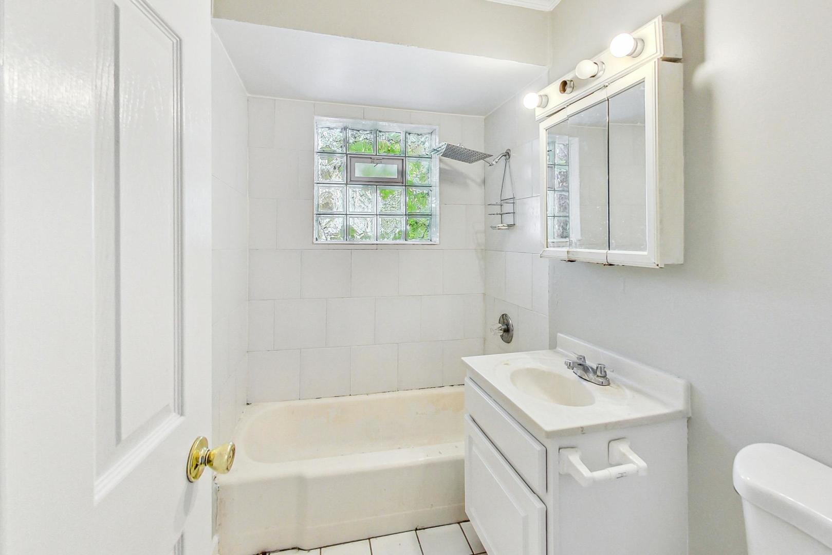 2212-2214 Oakton Street Park Ridge, IL 60068 - Photo 25 of 43 a bathroom with a sink a bathtub and a shower