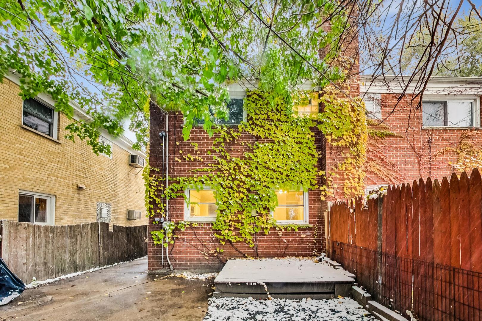 2212-2214 Oakton Street Park Ridge, IL 60068 - Photo 32 of 43 a view of a patio with couches and table and chairs and wooden fence
