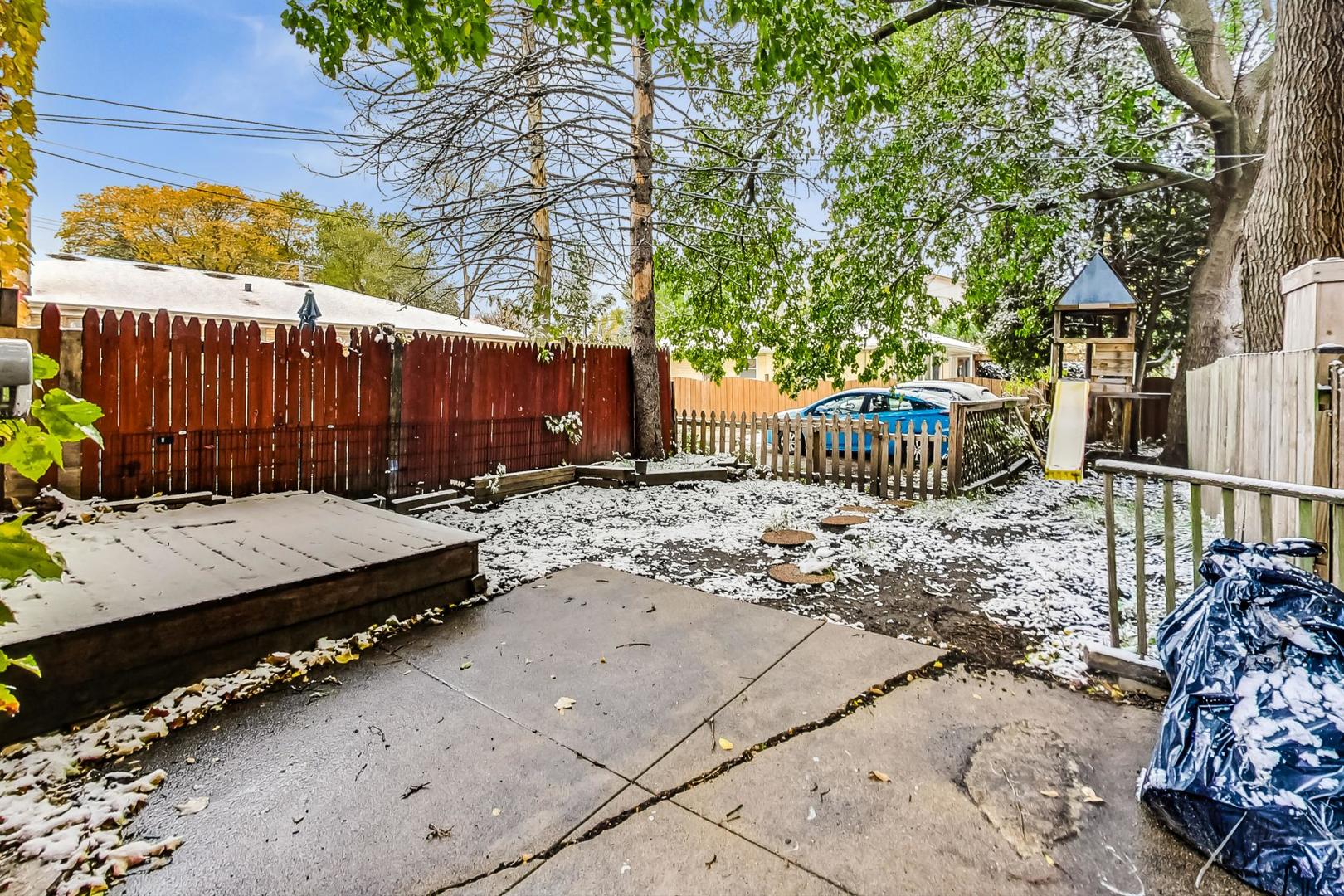 2212-2214 Oakton Street Park Ridge, IL 60068 - Photo 34 of 43 a view of a backyard with a small cabin and wooden fence