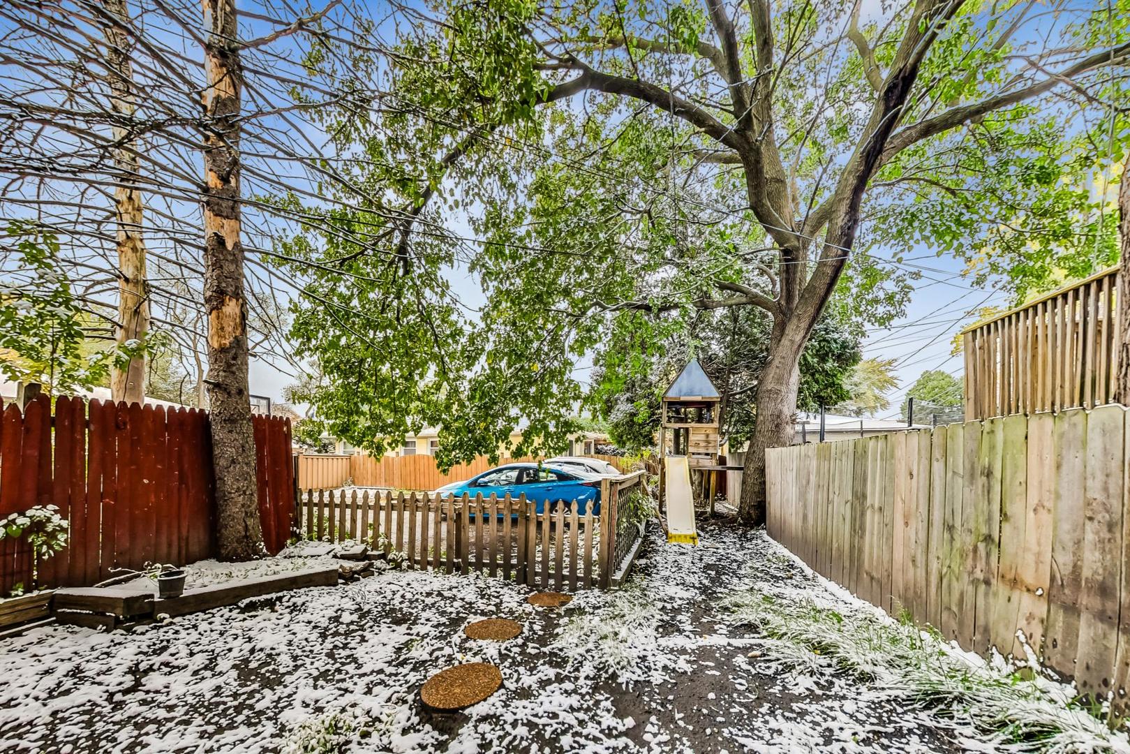 2212-2214 Oakton Street Park Ridge, IL 60068 - Photo 35 of 43 a view of a wooden fence next to a yard