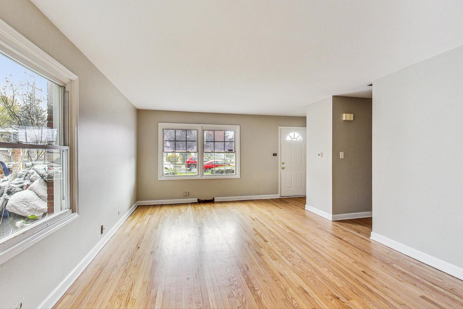 2212-2214 Oakton Street Park Ridge, IL 60068 - Photo 7 of 43 wooden floor in an empty room with a window