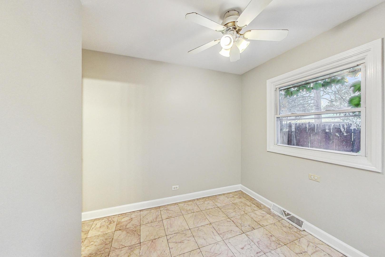 2212-2214 Oakton Street Park Ridge, IL 60068 - Photo 9 of 43 an empty room with windows and fan