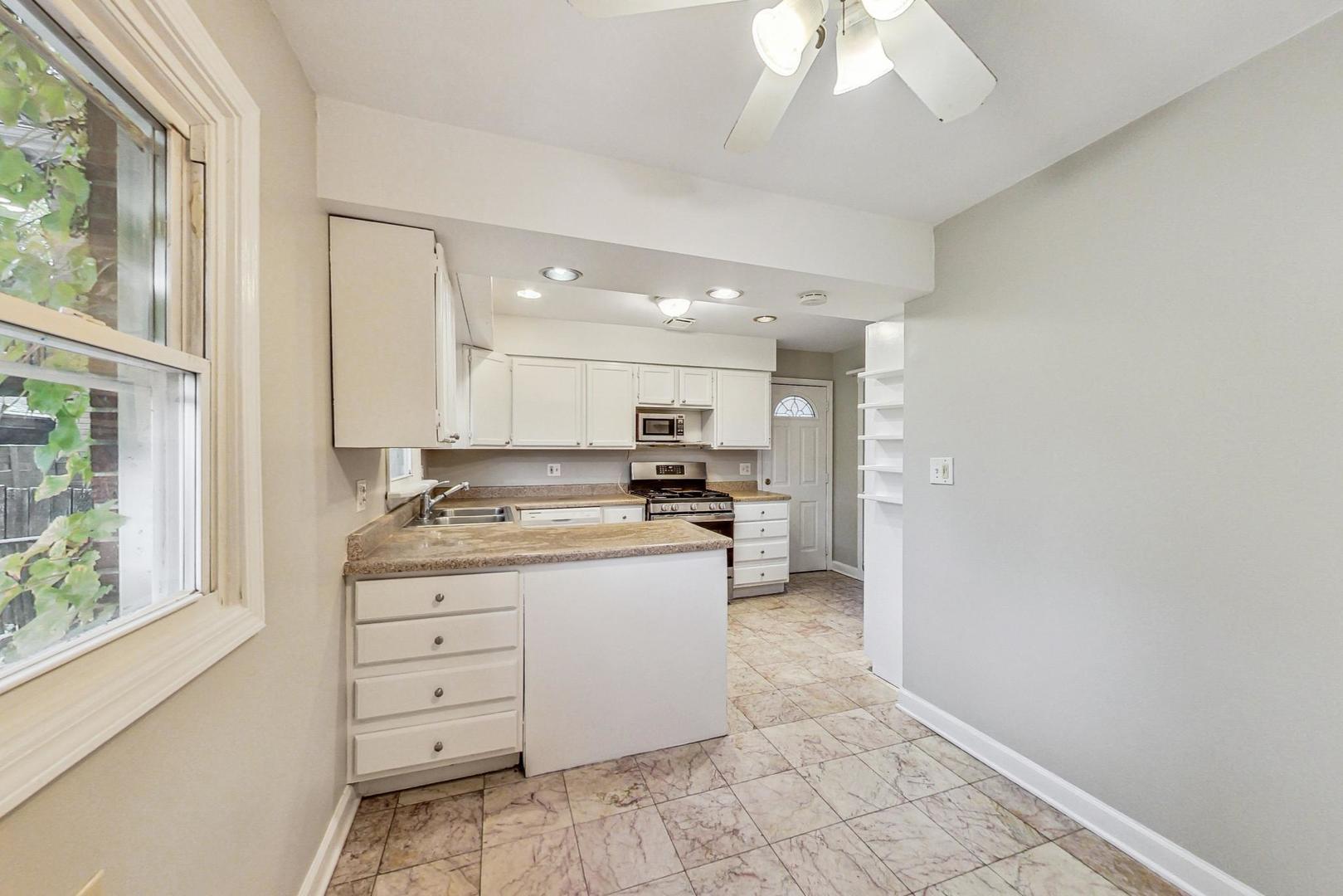 2212-2214 Oakton Street Park Ridge, IL 60068 - Photo 10 of 43 a kitchen with a refrigerator and a stove top oven