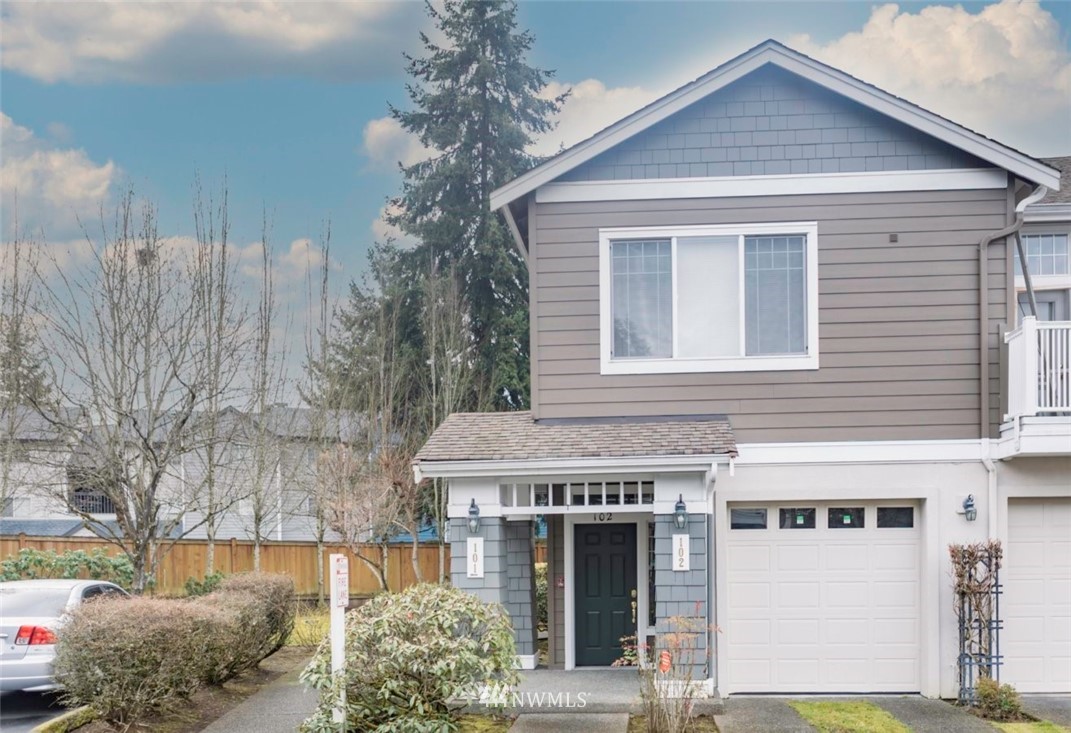 4319 Northeast 5th Court, Unit 102 Renton, WA 98059 - Photo 1 of 32 a front view of a house with garden