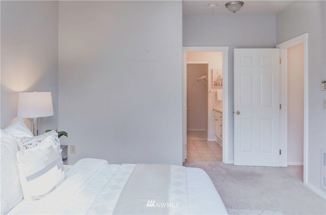 4319 Northeast 5th Court, Unit 102 Renton, WA 98059 - Photo 20 of 32 a bedroom with a bed and a lamp