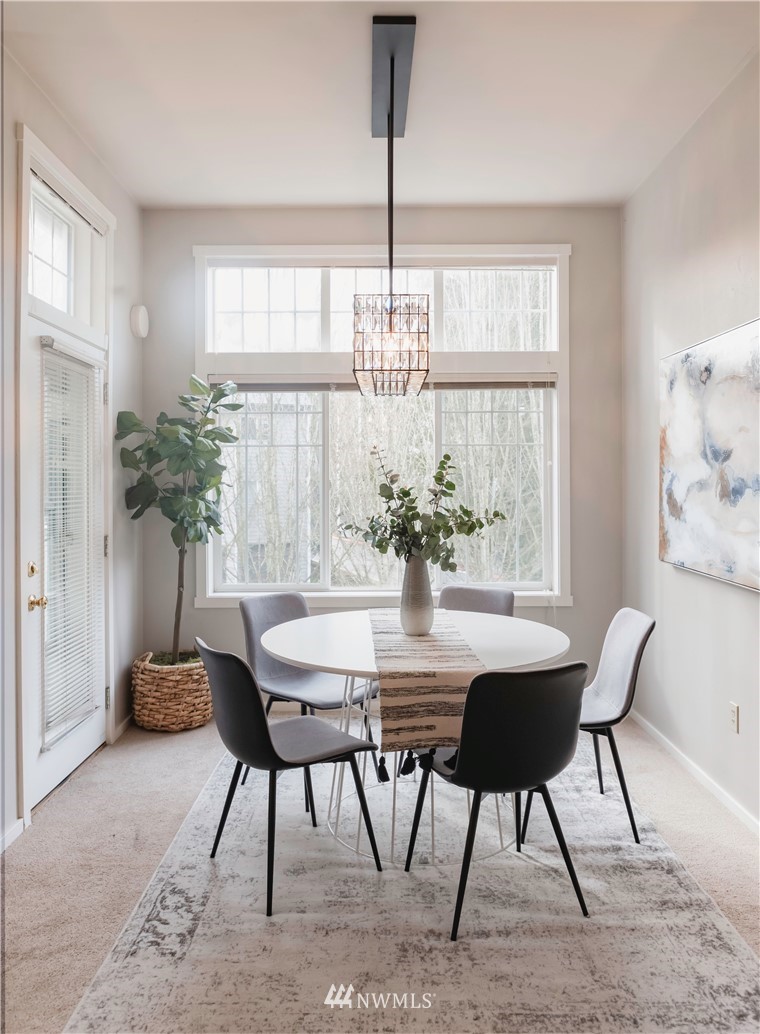 4319 Northeast 5th Court, Unit 102 Renton, WA 98059 - Photo 9 of 32 a view of a dining room with furniture window and outside view
