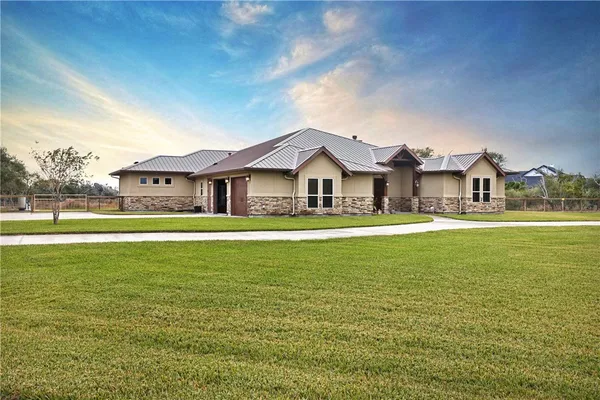 a front view of a house with a garden