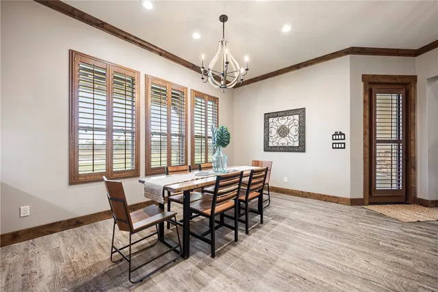a kitchen with kitchen island a counter top space a sink stainless steel appliances and cabinets