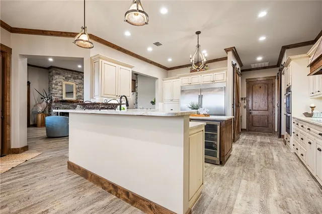 a kitchen with center island appliances and cabinets