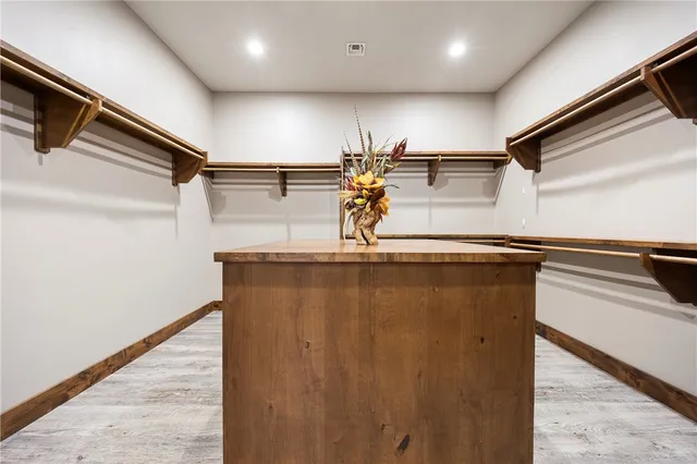 a kitchen with stainless steel appliances cabinets and wooden floor