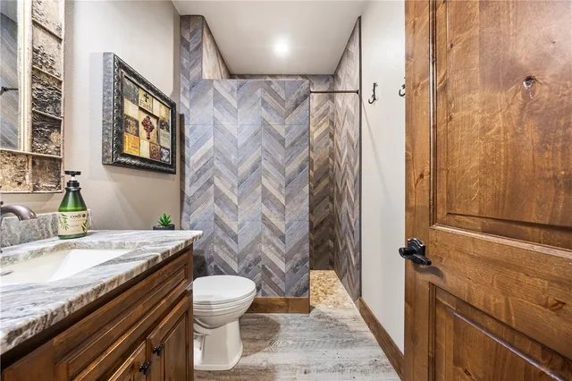 a bedroom with a bed and a ceiling fan