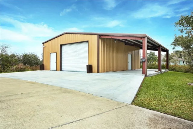 a view of a house with a backyard