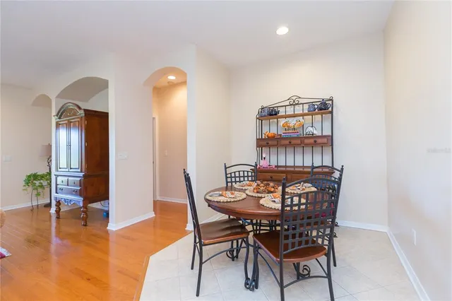a dining room with furniture and wooden floor