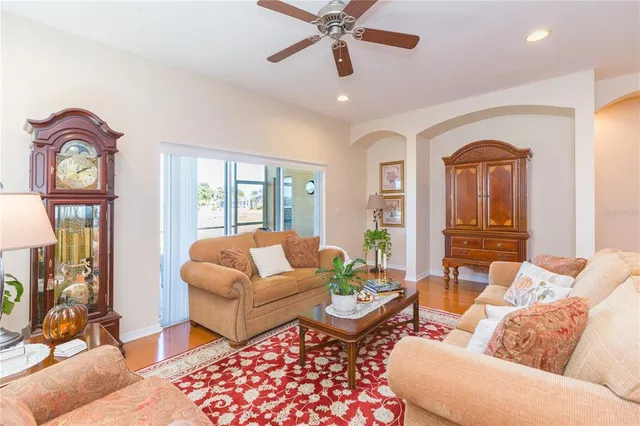 a living room with furniture a rug and a window