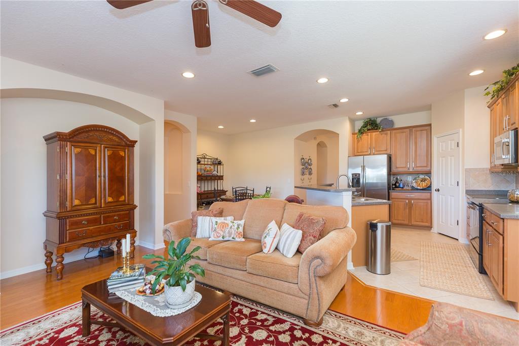 2816 Graphite Court Valrico, FL 33594 - Photo 19 of 57 a living room with furniture kitchen view and a chandelier