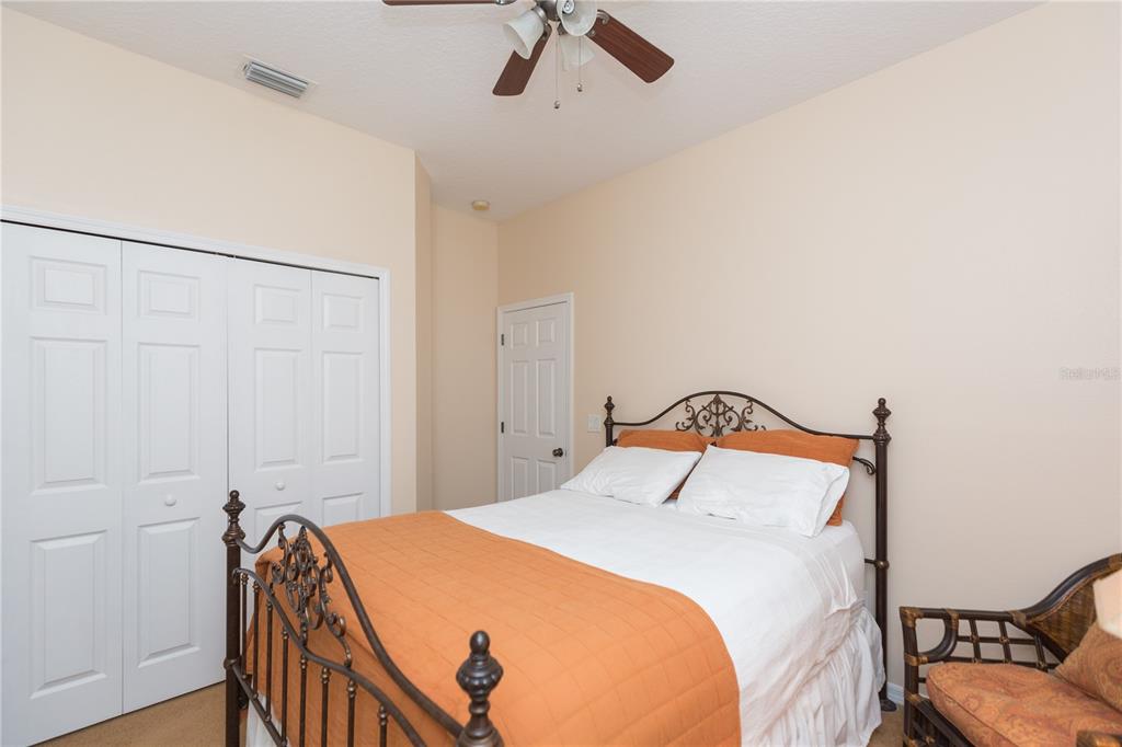 2816 Graphite Court Valrico, FL 33594 - Photo 24 of 57 a bedroom with a bed and a chandelier