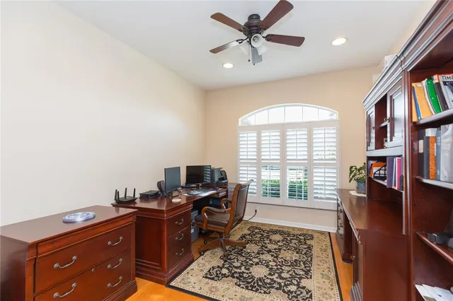 a view of a workspace with furniture and a window