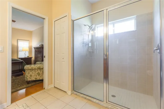 a bathroom with a glass shower door